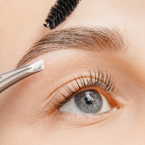 Master tweezers depilation of eyebrow hair in women, brow correction